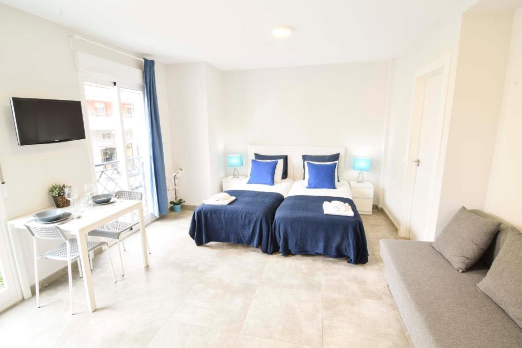 Posteľ alebo postele v izbe v ubytovaní Apartamentos CENTRO SALECIANOS