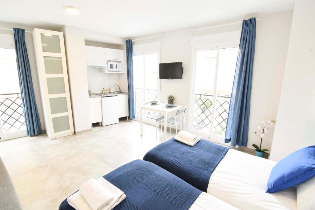 Posteľ alebo postele v izbe v ubytovaní Apartamentos CENTRO SALECIANOS