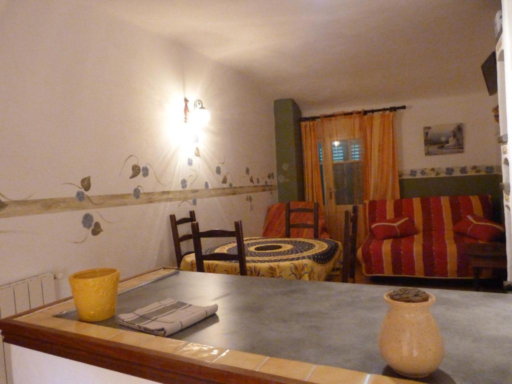 a kitchen with a table and a living room at Campagne SAINT MAURINET in Montmeyan