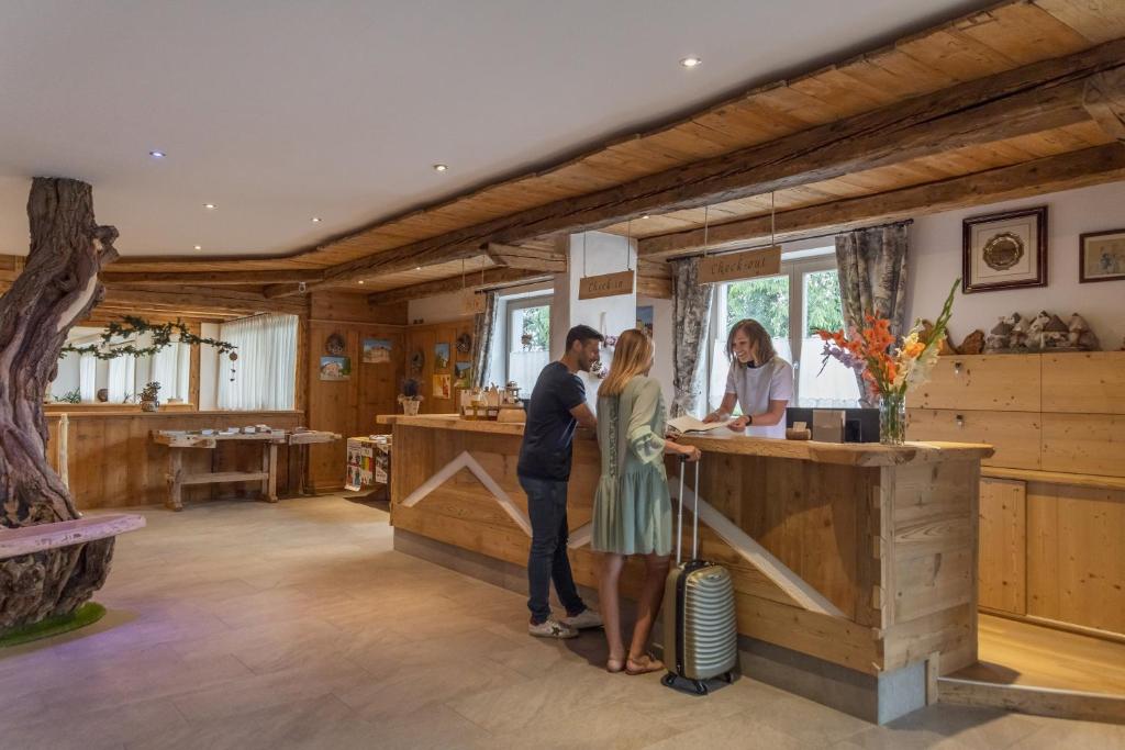 a group of people standing at a counter in a house at Miraval Hotel in Coredo