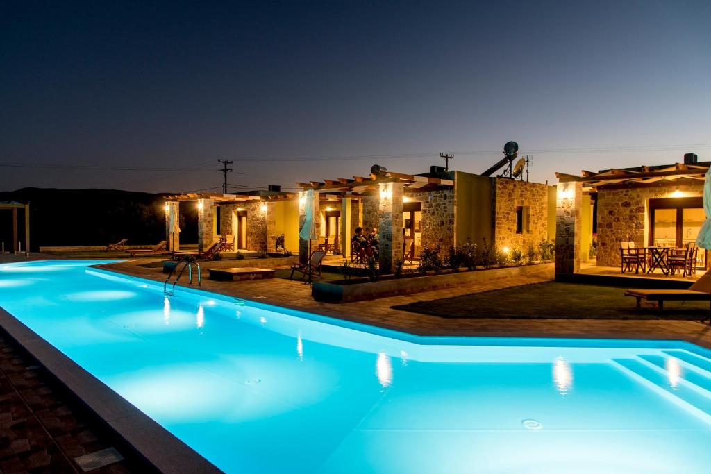 a swimming pool in front of a house at night at ONAR in Palekastron