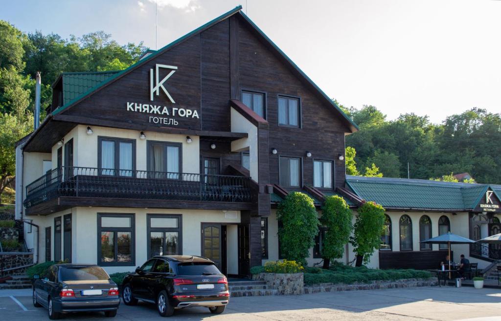 a building with a sign on the front of it at Knyazha Hora Hotel in Kaniv