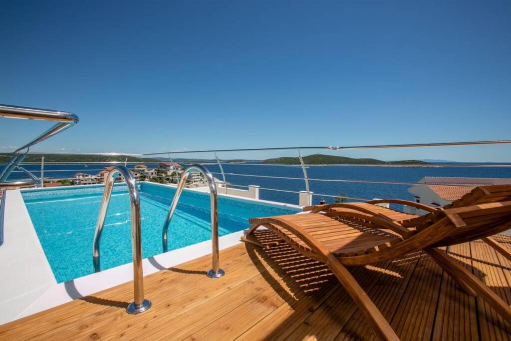 a deck with a chair and a pool on a boat at Villa Cerjan - Sevid in Sevid