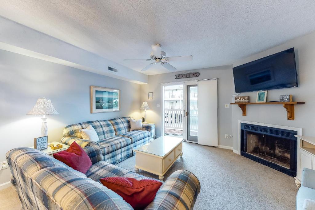 a living room with two couches and a fireplace at Oceanblock 61st C102 in Ocean City