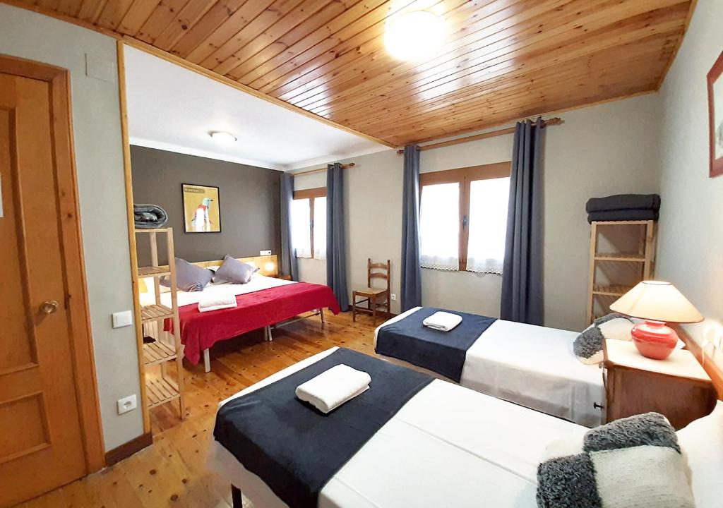a hotel room with two beds and a room with at Hostal Fonda Prat in Puigcerdà