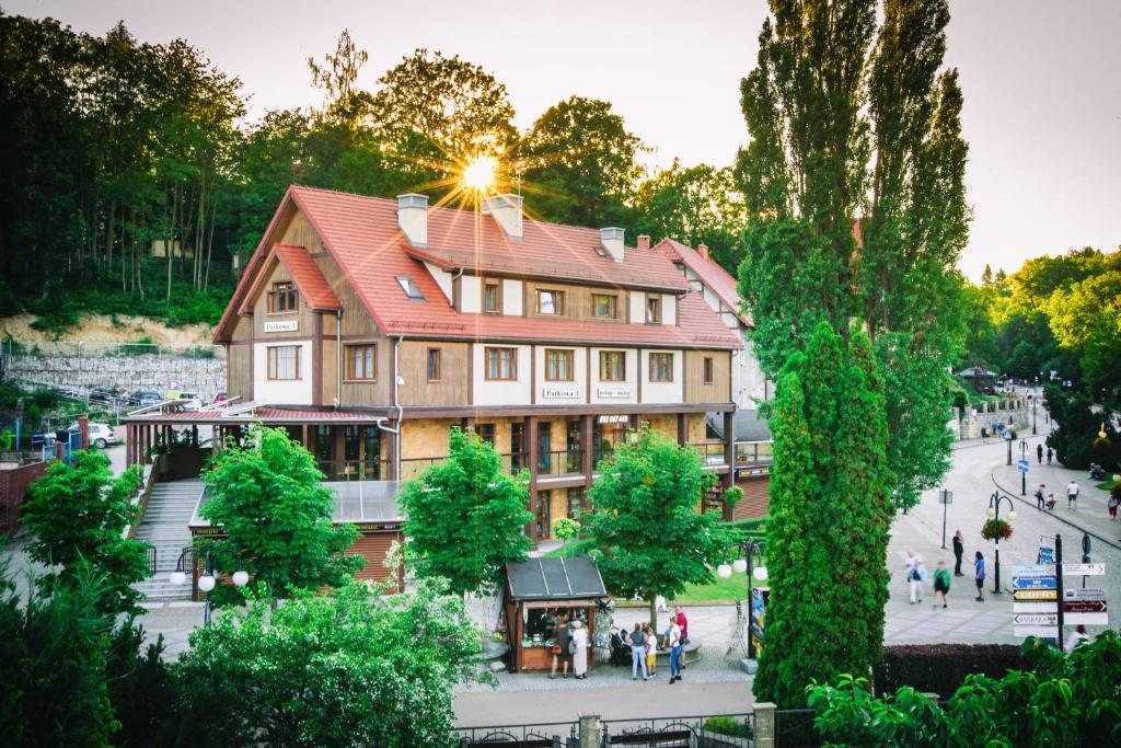 a large building with people walking in front of it at Parkowa 3 in Polanica-Zdrój