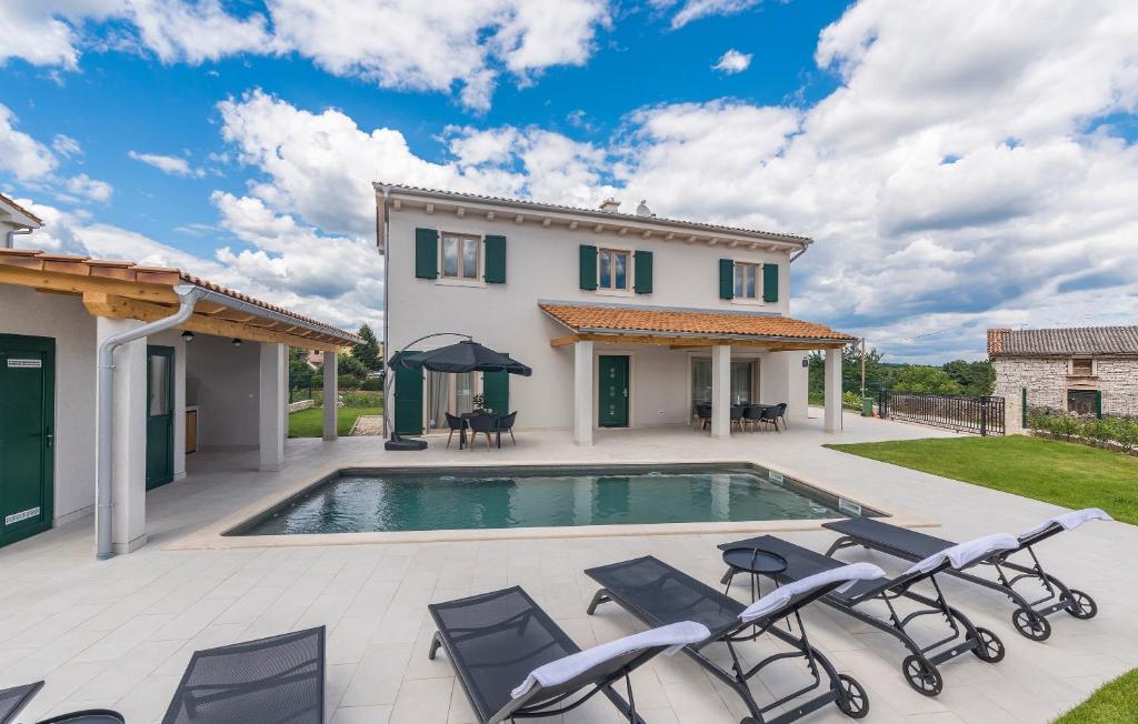 a villa with a swimming pool and patio furniture at Martinela Villas Istria - Villa Vito in Barban