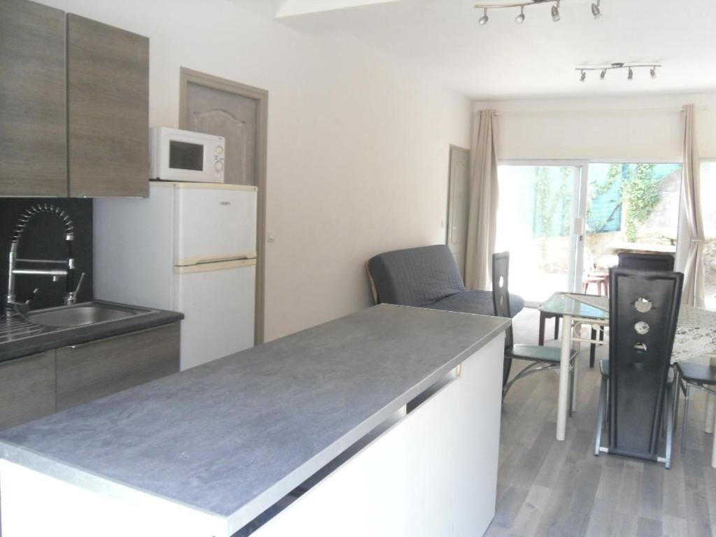 a kitchen with a sink and a counter top at appartement saisonnier in Sorède