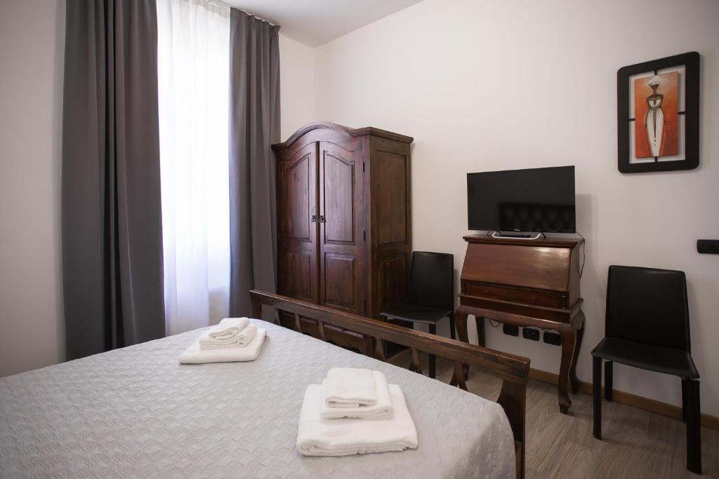 Postel nebo postele na pokoji v ubytování Hotel Amico
