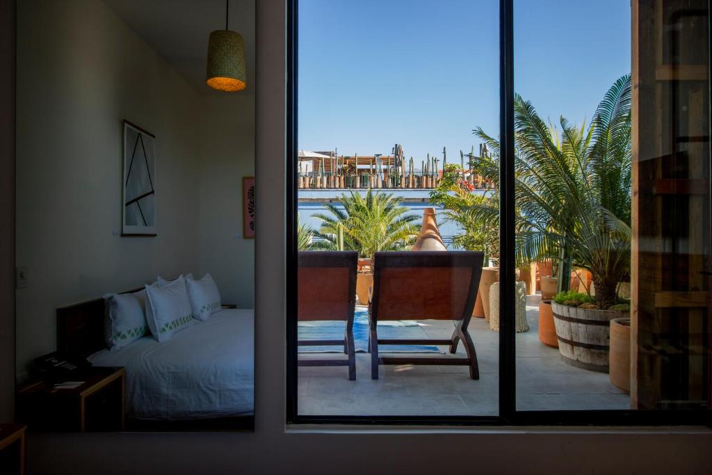 a bedroom with a bed and a bed and a window at Hotel Los Amantes in Oaxaca City