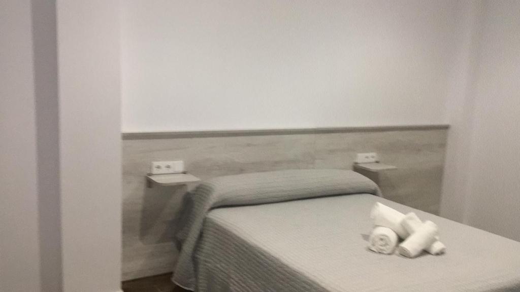 Postel nebo postele na pokoji v ubytování Alojamiento Saturno 1