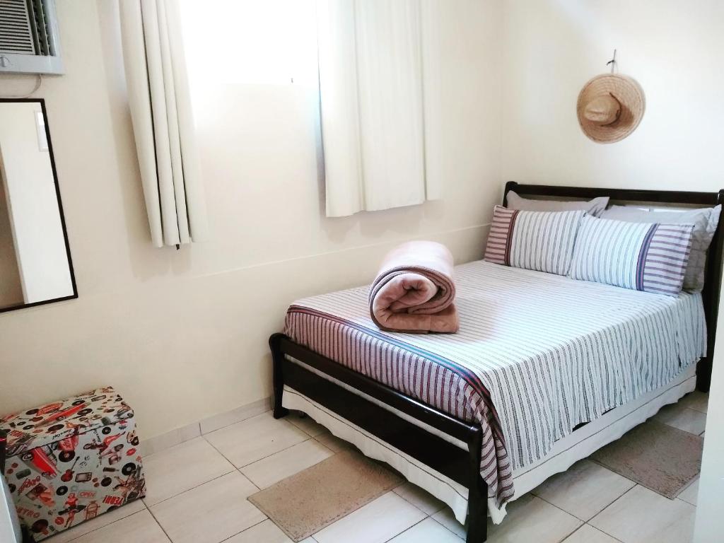 a bed with a towel on it in a room at Casa Julieta in Resende