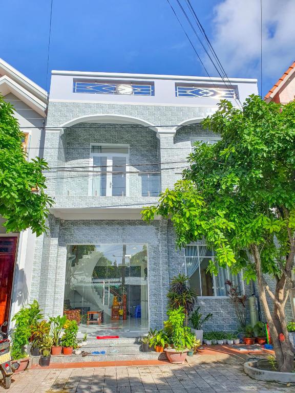 a large brick building with trees in front of it at MƯỜI HOMESTAY in Con Dao