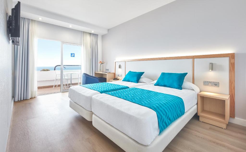 a bedroom with a large bed with a view of the ocean at Hotel Lancelot in Arrecife