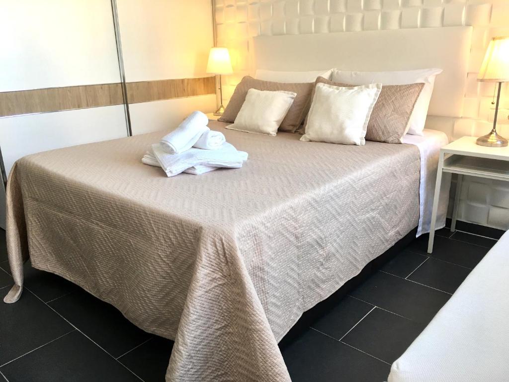 a hotel room with a bed with towels on it at Estudio junto La Nogalera 1 in Torremolinos