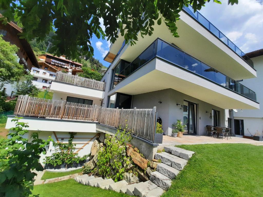 a house with a balcony and a yard at Nauers in Kappl