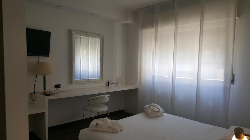 Postel nebo postele na pokoji v ubytování Hotel Cristallo