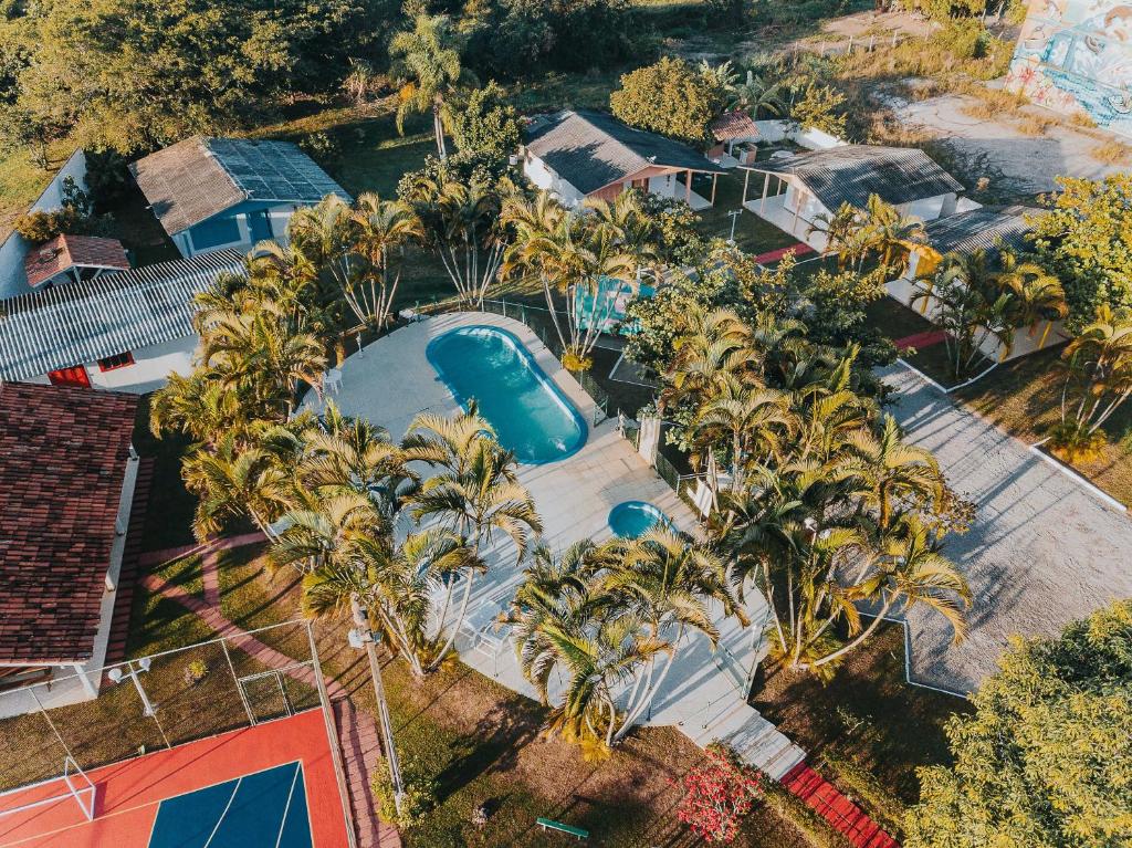 an overhead view of a swimming pool with palm trees at La Ville Residence in Florianópolis