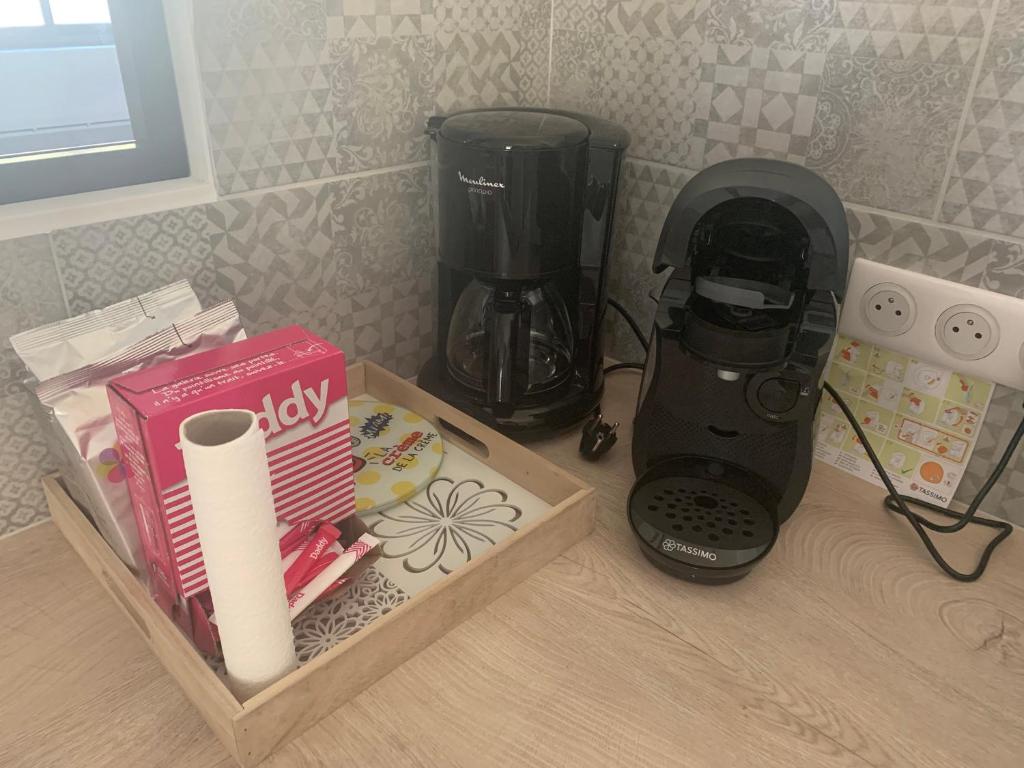 a black blender sitting on a counter next to a box at L&#39;Arbois 1876-La Verrière- in Arbois