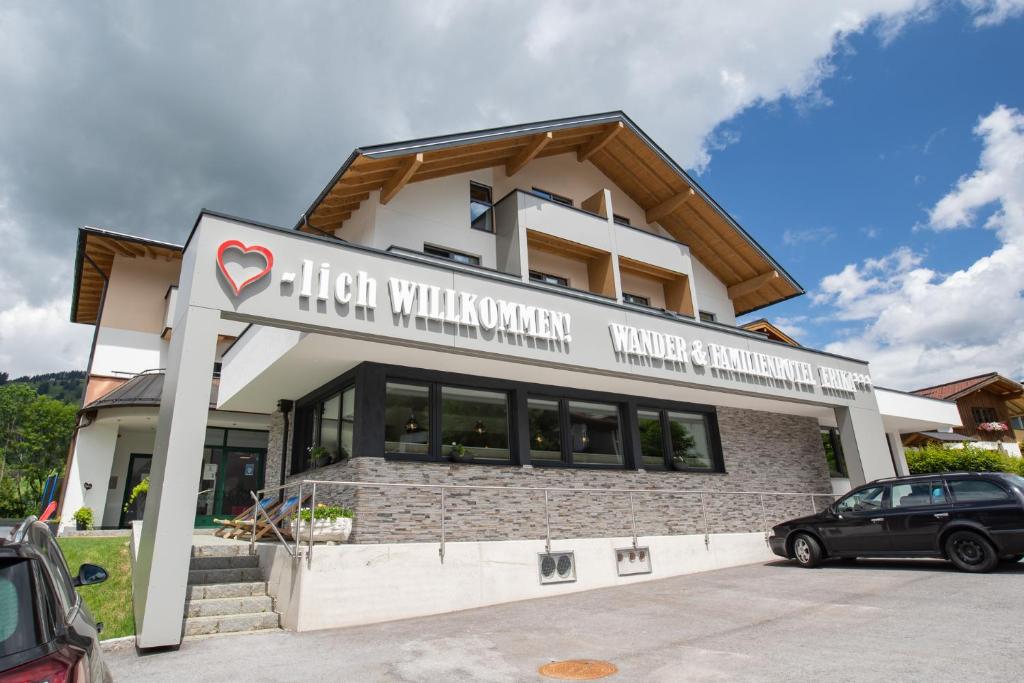 a building with a car parked in front of it at Wanderhotel Erika in Wagrain