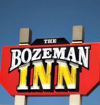 a sign for the bohemian inn with a blue sky at Bozeman Inn in Bozeman