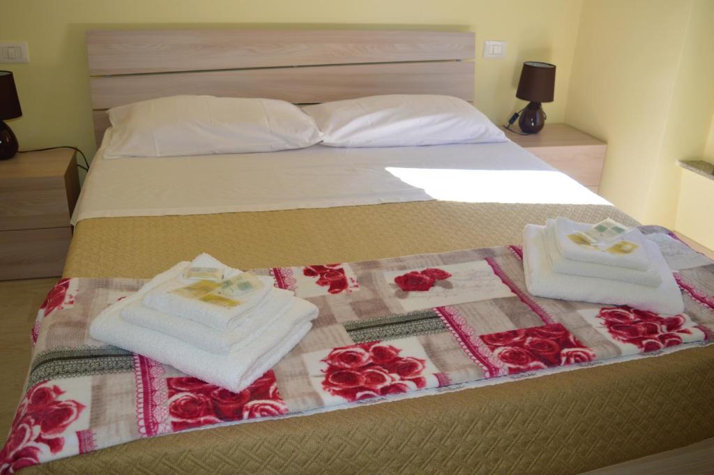 een bed met twee handdoeken en rozen erop bij Da zia Rosina in Lamezia Terme