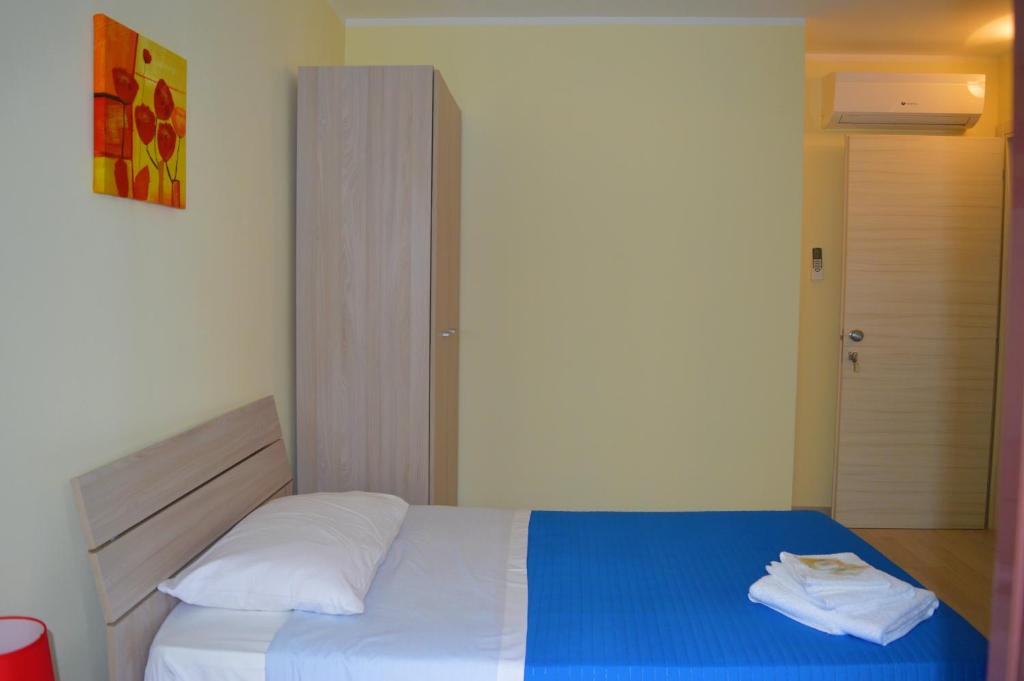 a bedroom with a bed with a blue and white blanket at Da zia Rosina in Lamezia Terme