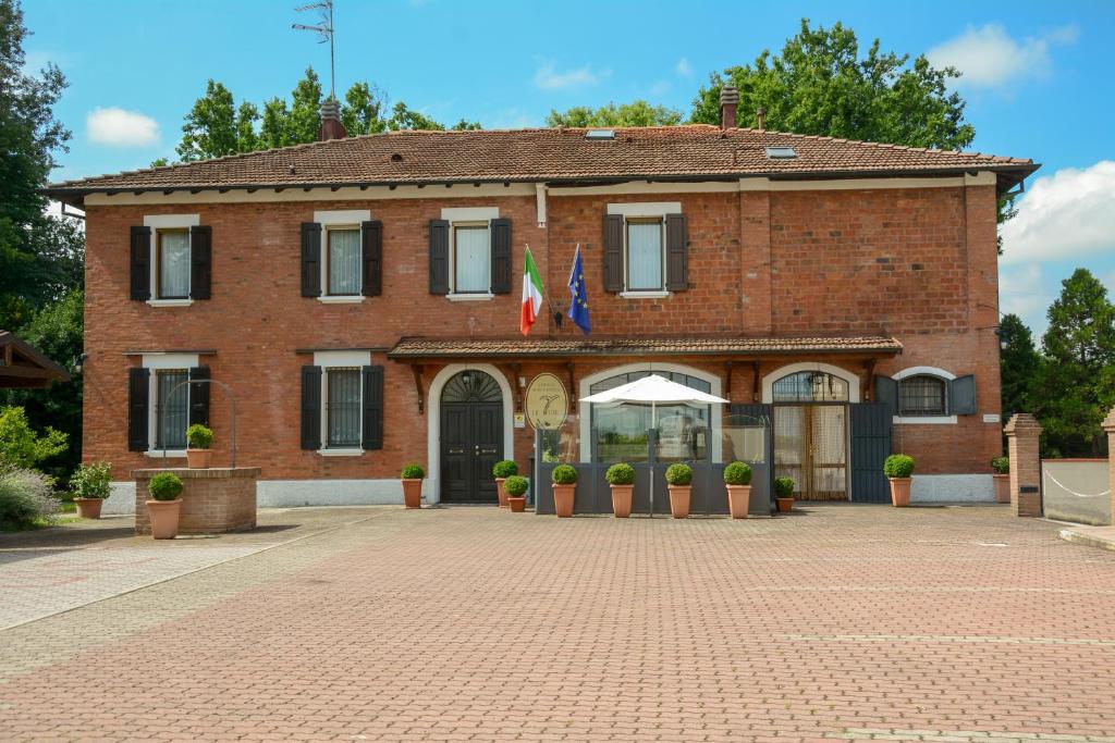 a brick building with flags in front of it at Le Tuie in Bologna