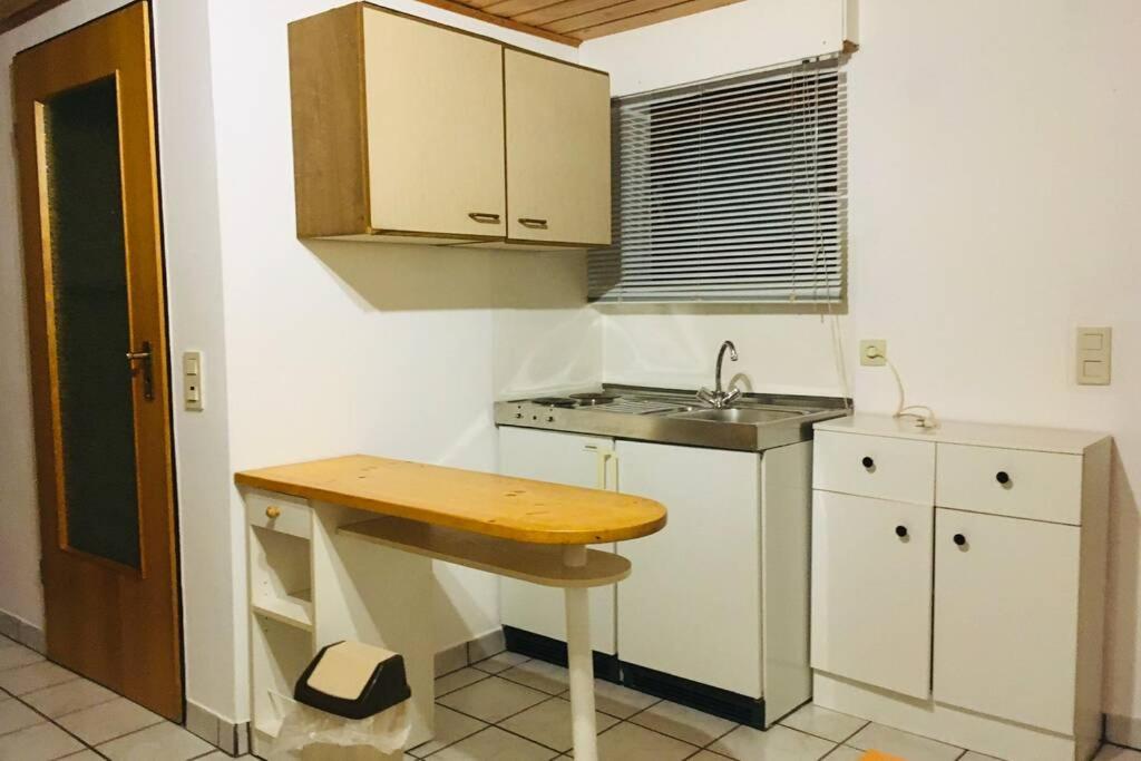a small kitchen with a sink and a counter at Biete ruhige Zwei-Zimmer Souterrain-Wohnung in Niederkassel