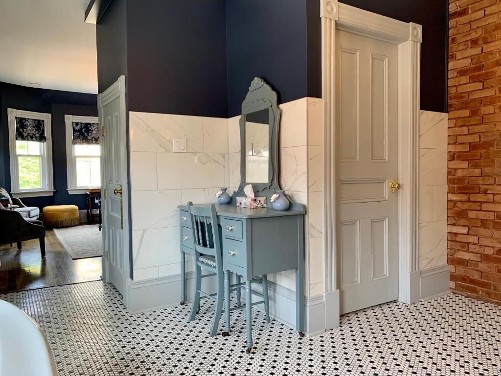 a dressing room with a blue table and a mirror at Slaymaker & Nichols Gastro House & Inn in Charlottetown