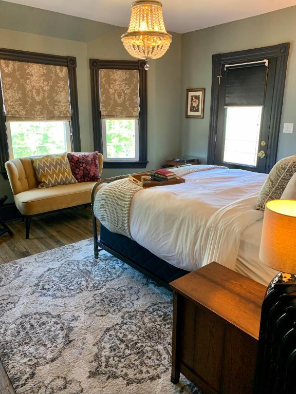 a bedroom with a large bed and a couch at Slaymaker & Nichols Gastro House & Inn in Charlottetown