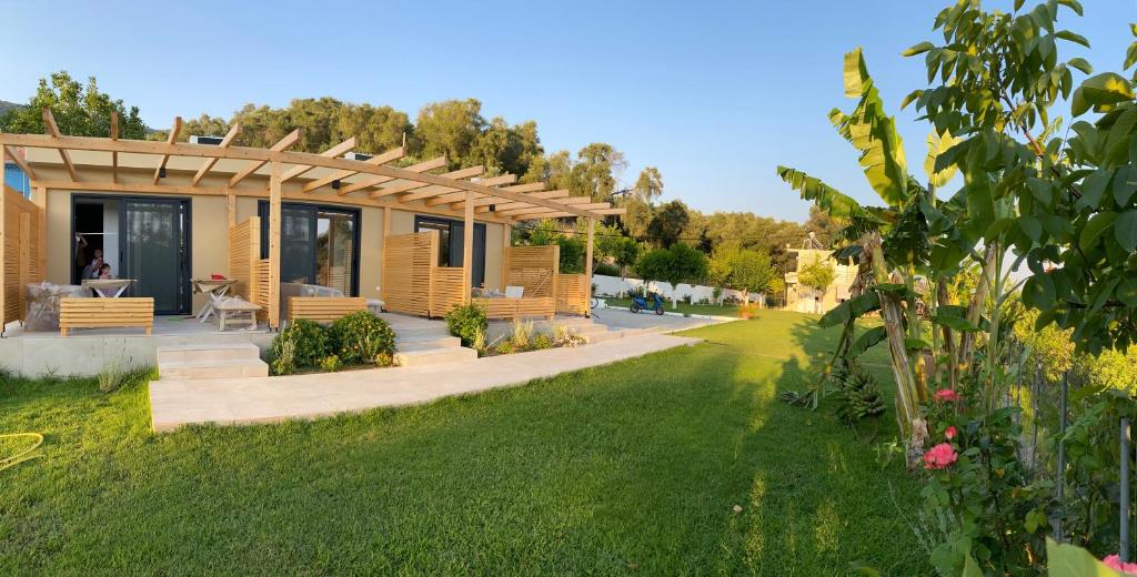 a house with a garden with a grass yard at Icons Experience in Parga