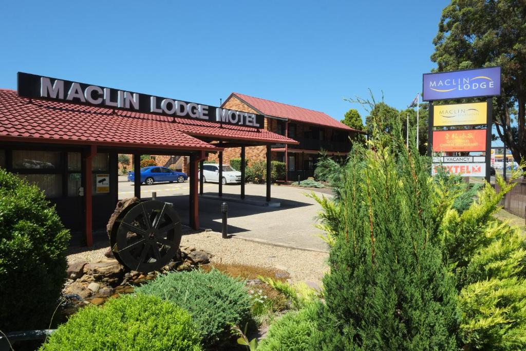 a building with a sign for a machin love motel at Maclin Lodge Motel in Campbelltown