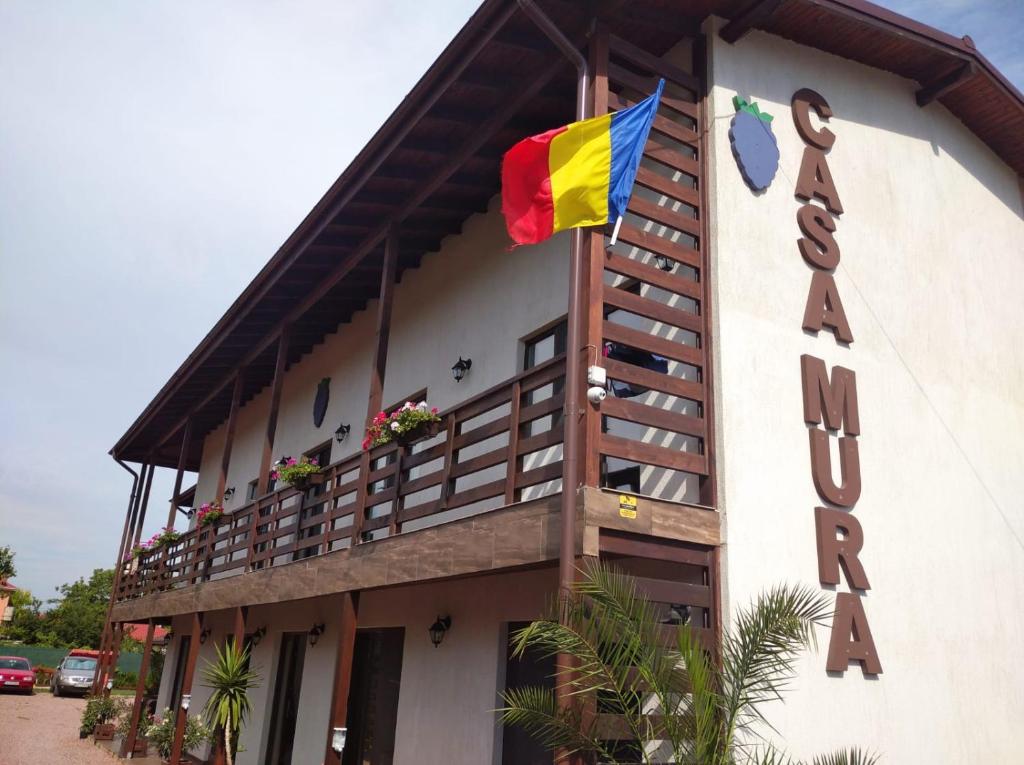 a building with a flag on the side of it at Casa Mura in 2 Mai
