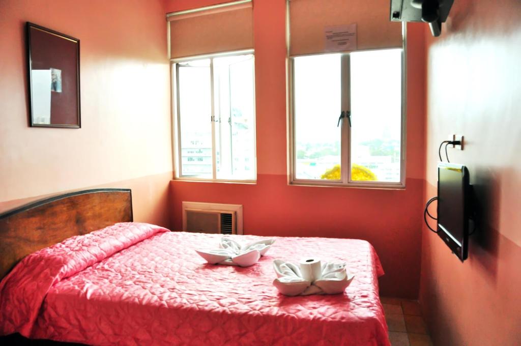 Postel nebo postele na pokoji v ubytování GV Tower Hotel