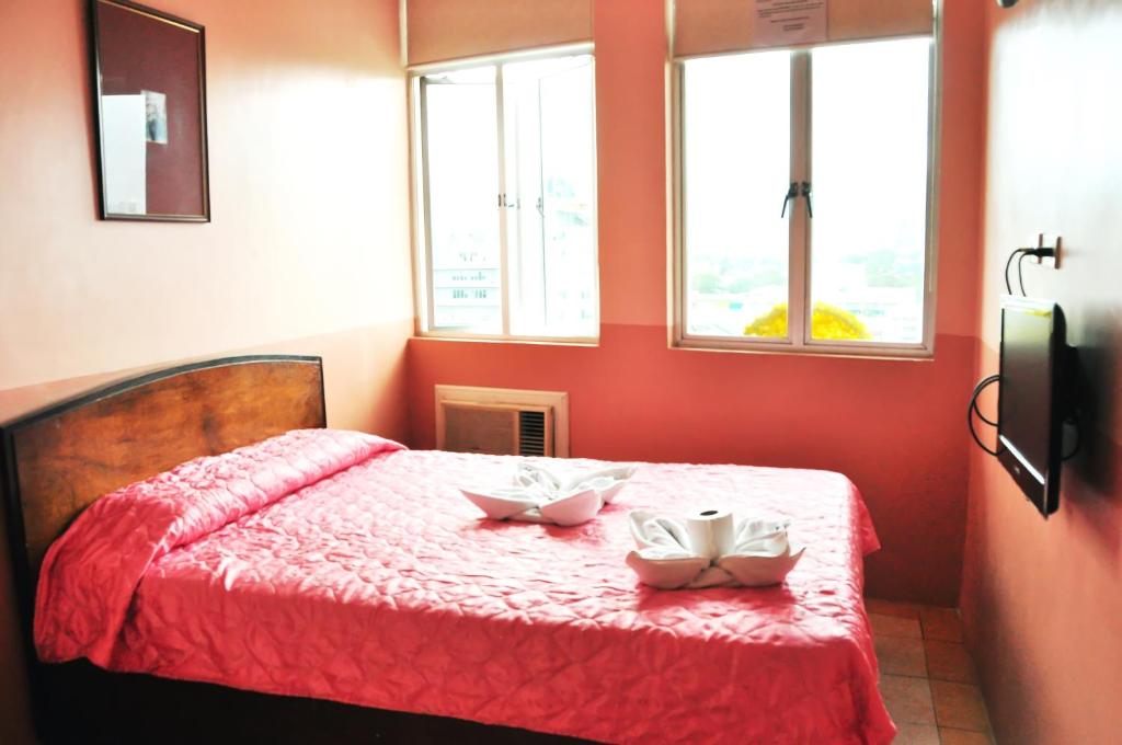Postel nebo postele na pokoji v ubytování GV Tower Hotel