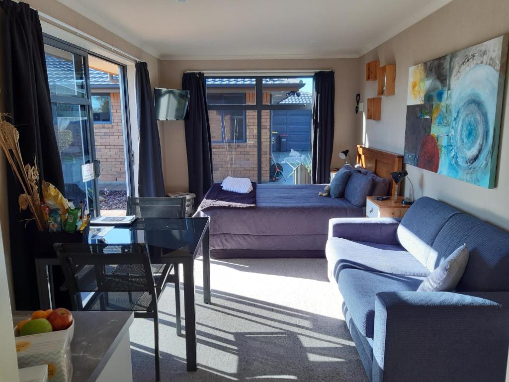 a living room with a couch and a table at Modern BNB unit with Wifi and Breakfast in Greymouth