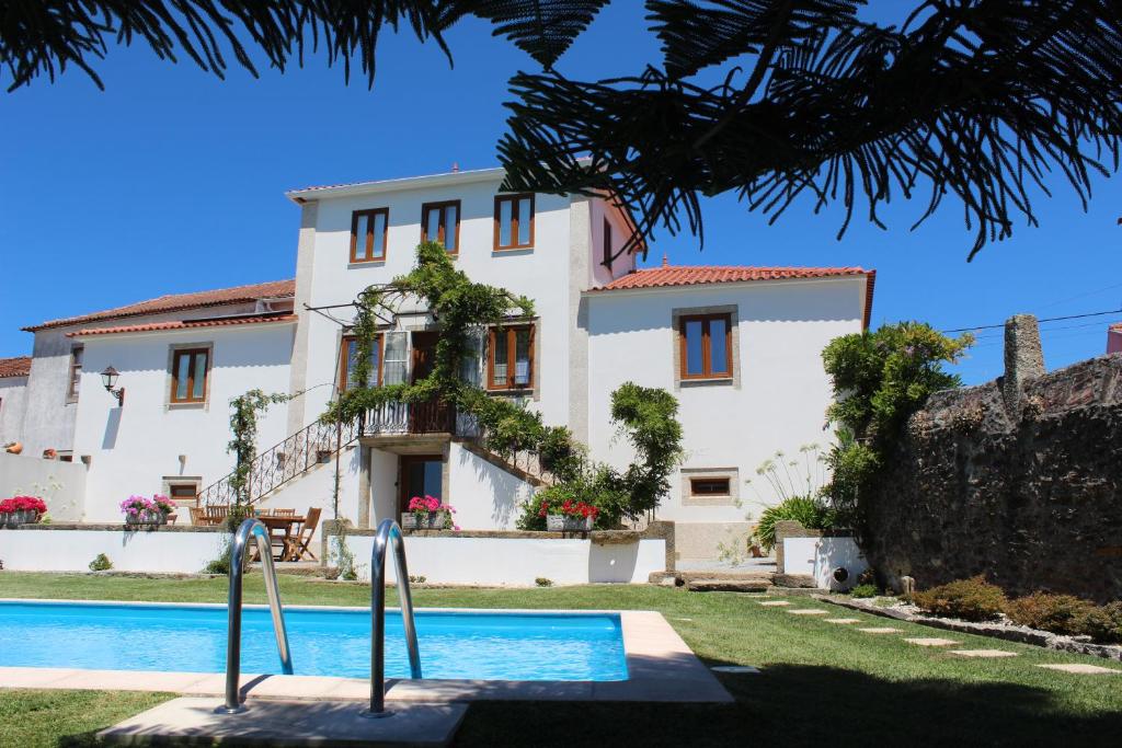 a house with a swimming pool in front of it at Casa Pena in Barcelos