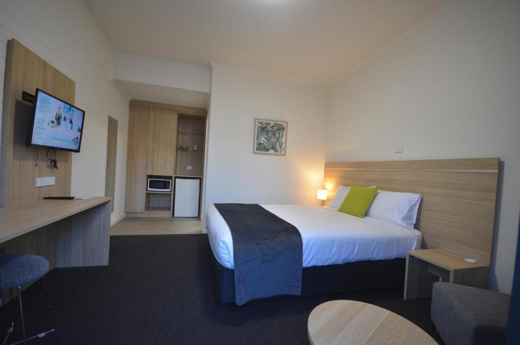 a hotel room with a bed and a tv at Frewville Motor Inn in Adelaide