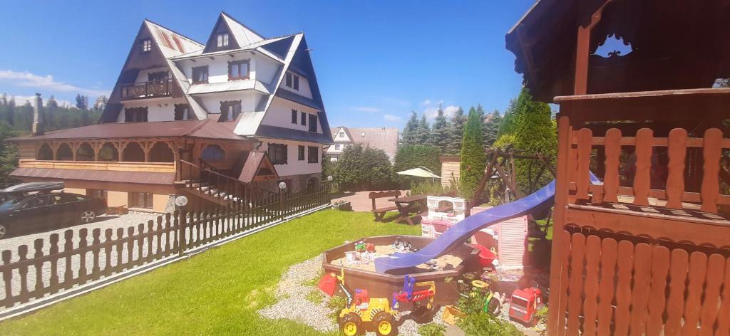 a model of a house with a toy train in a yard at U Białasów in Małe Ciche