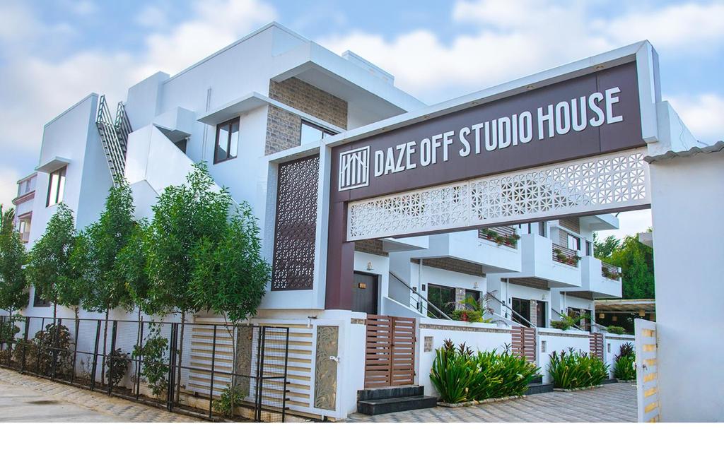 a building with a sign for a school house at Daze Off Studio house in Bhuj