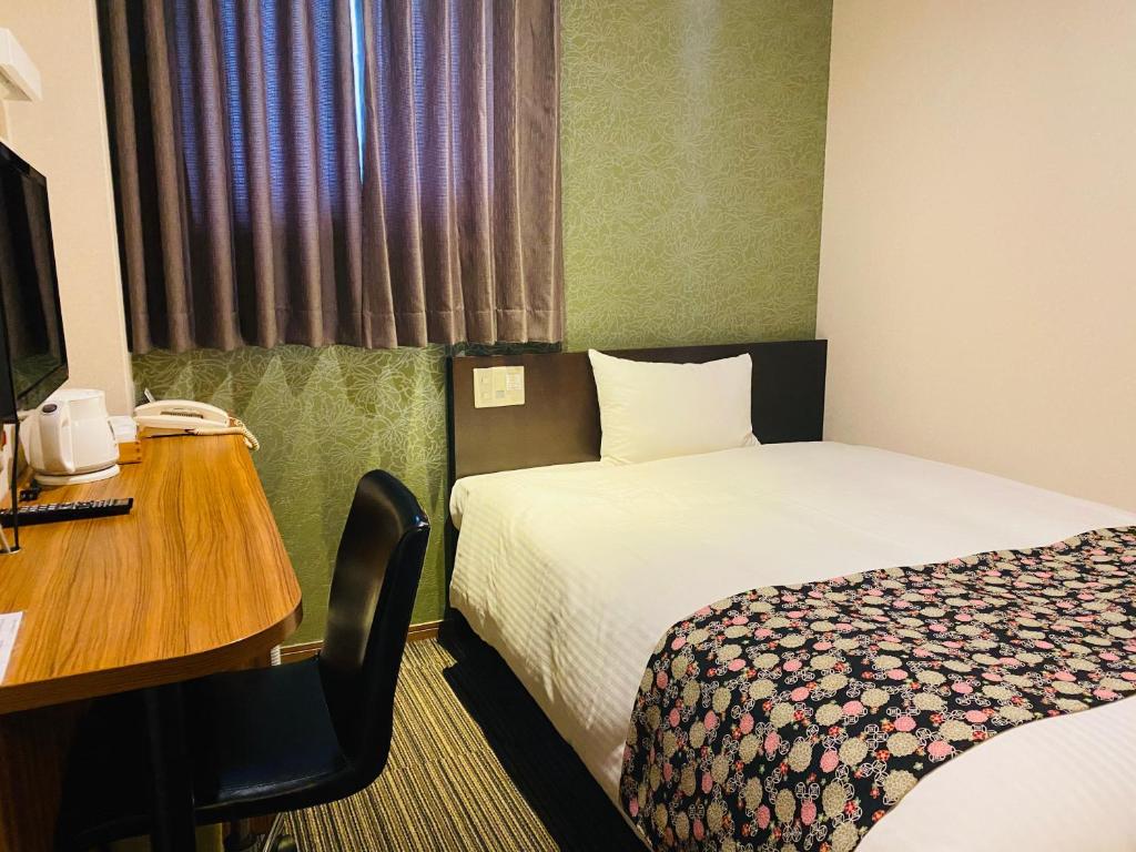 Postel nebo postele na pokoji v ubytování Ueno Touganeya Hotel