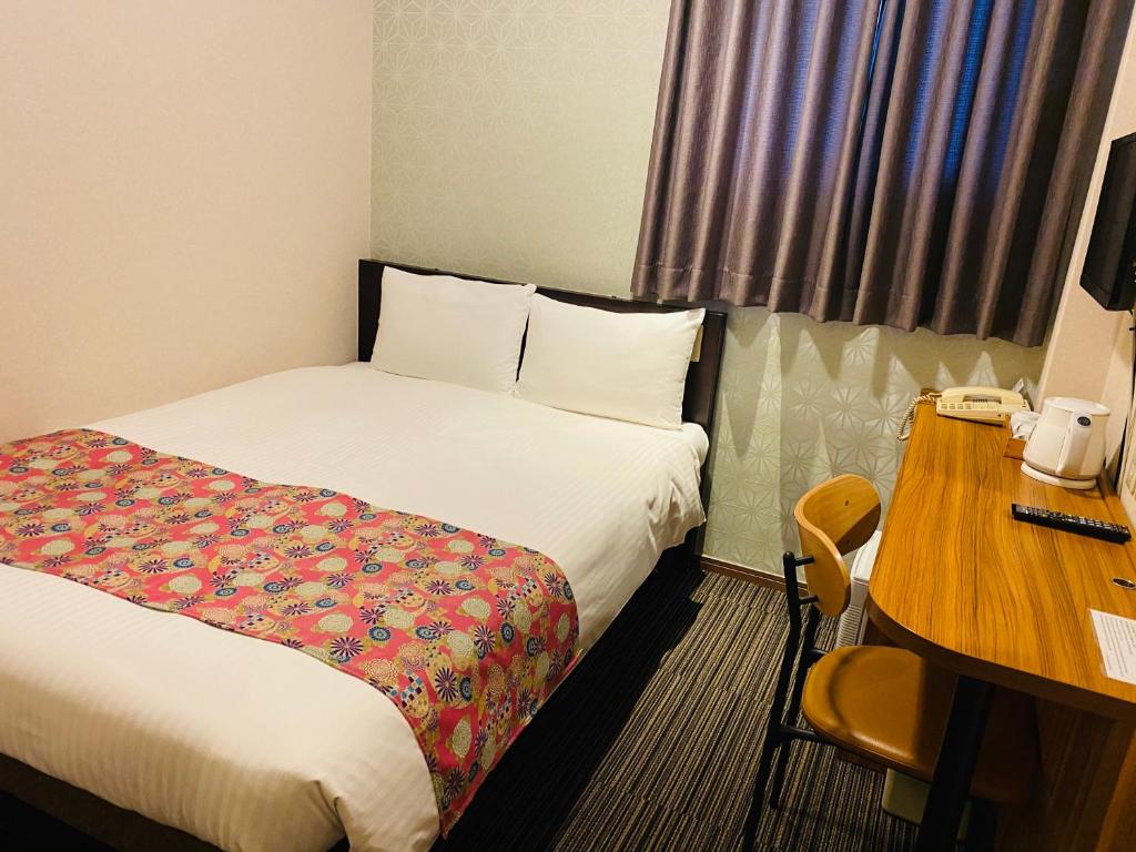 Postel nebo postele na pokoji v ubytování Ueno Touganeya Hotel