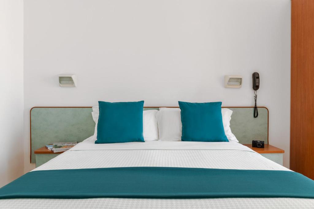 Postel nebo postele na pokoji v ubytování Hotel Très Jolie