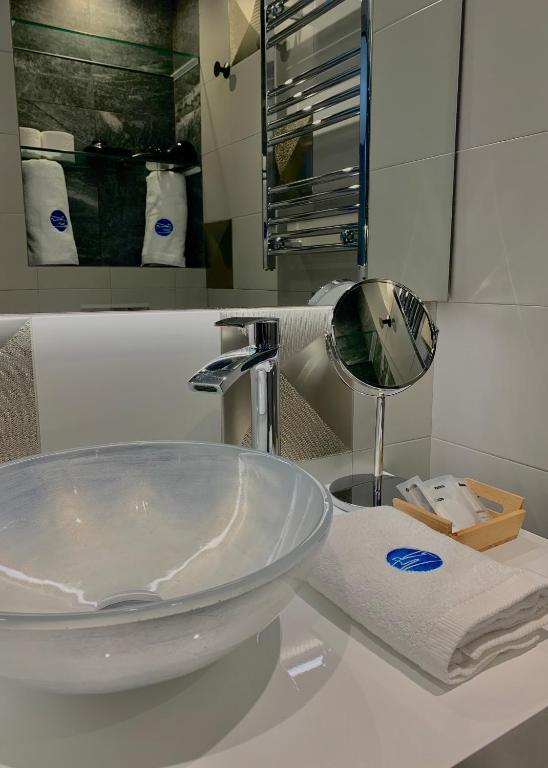 a bathroom with a sink and a mirror on a counter at Mamma Mia Hotel Boutique - Only Adults in Tossa de Mar