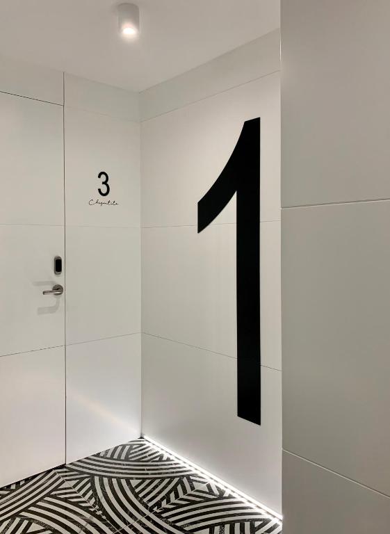 a number in a white wall with a floor at Mamma Mia Hotel Boutique - Only Adults in Tossa de Mar