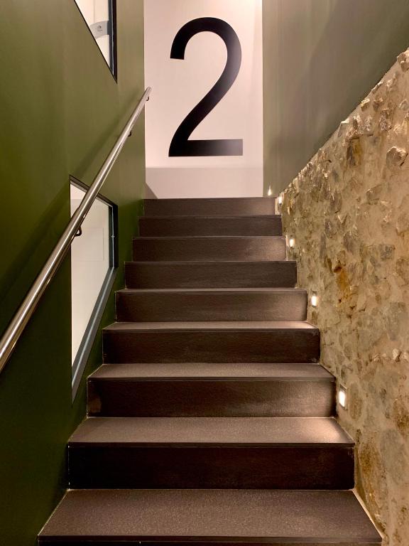 a staircase with a number on the wall at Mamma Mia Hotel Boutique - Only Adults in Tossa de Mar