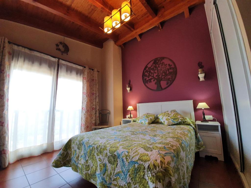 a bedroom with a large bed and a window at Aptos. Rurales Los Falares de la Abuela Berta (Adults Only) in Nieda