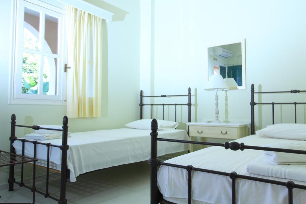 A bed or beds in a room at iliobasilema studios & apartments