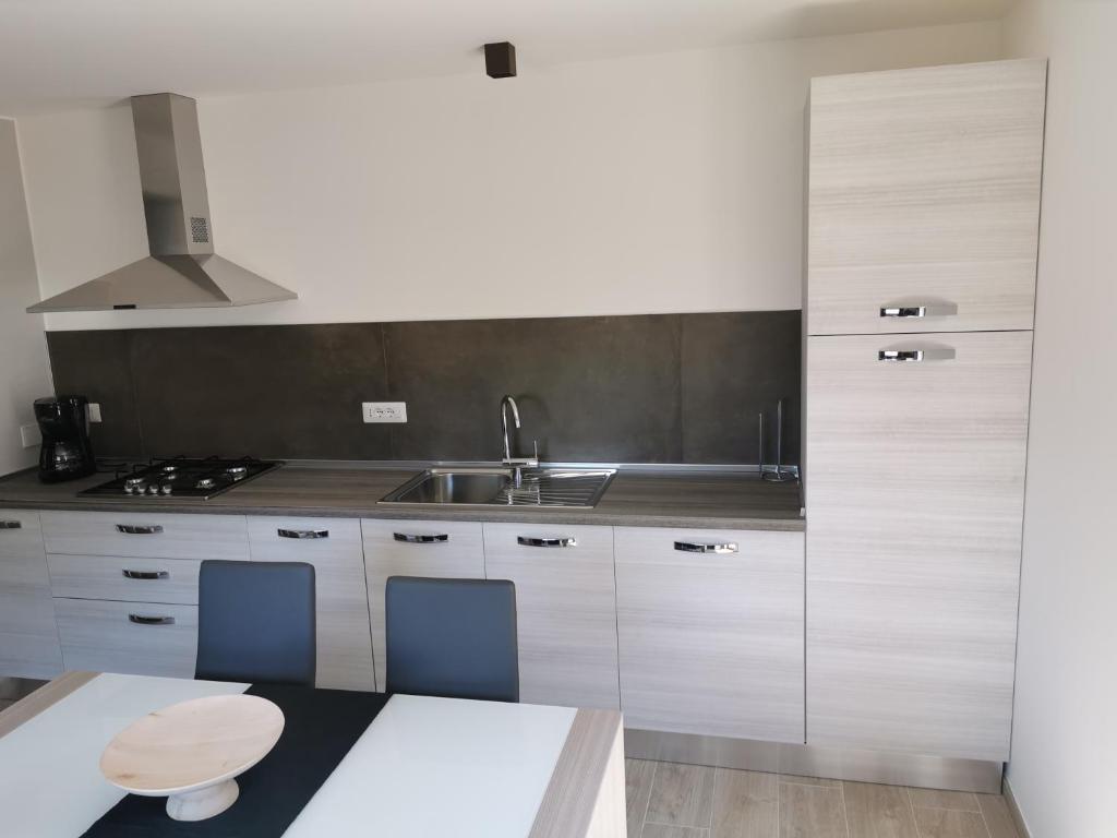 a kitchen with a sink and a counter top at La Maison D' Amelie in Fenis